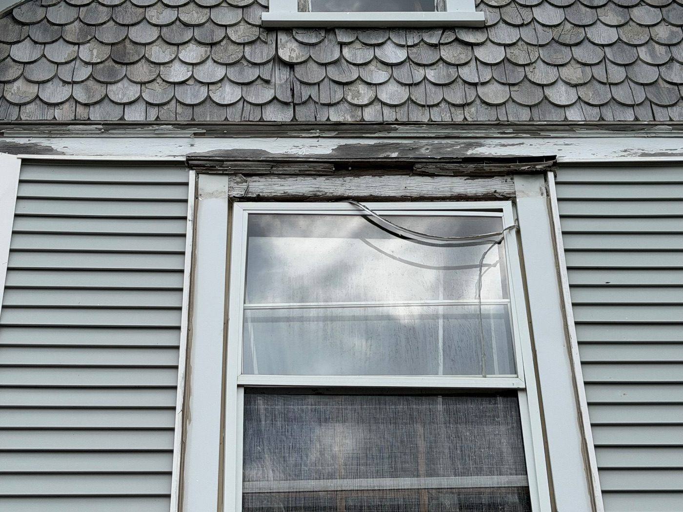 Before: rotted window header, the kind of thing we find and fix