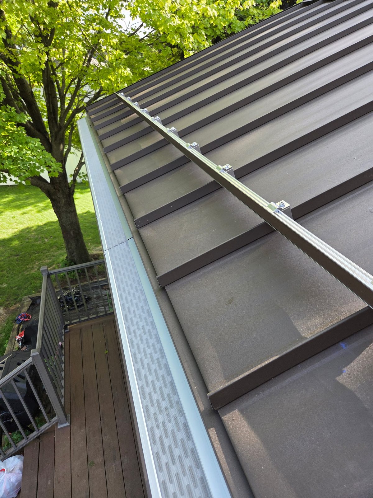 Our micro-mesh guards on a standing-seam metal roof (roof by our metal guy, one network, one house)