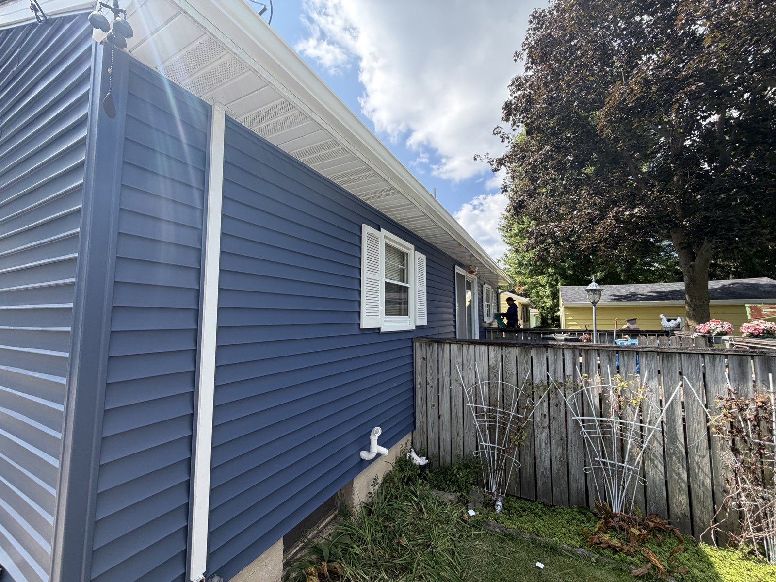 Navy siding, white soffit and fascia, the full flip