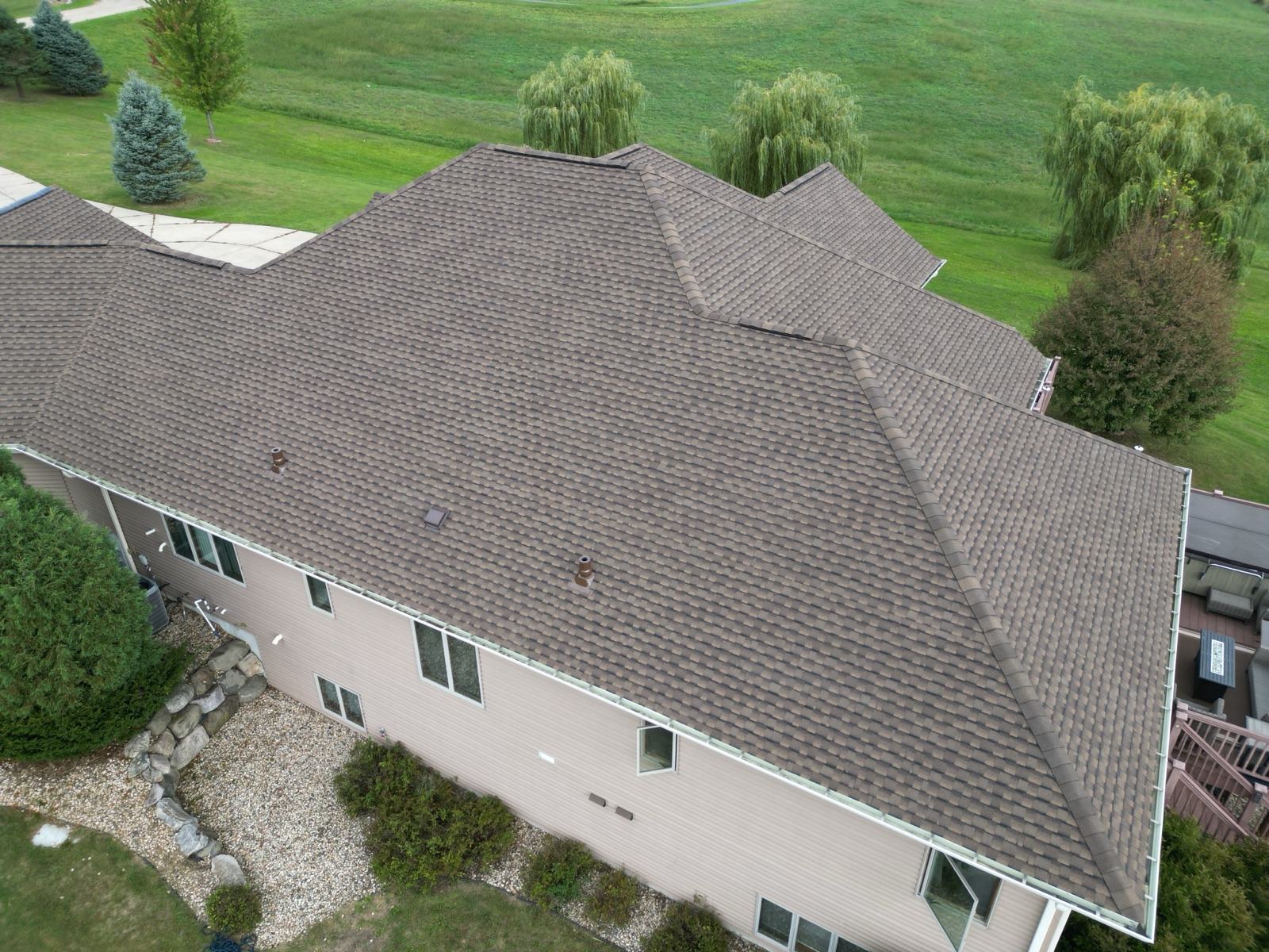Close drone view of the finished driftwood architectural shingles and clean valleys